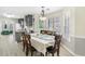Charming dining room with bay window, hardwood floors and view into the modern kitchen at 3589 Garden Manor Dr, Loganville, GA 30052