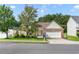 Charming one-story home with brick facade, manicured lawn, and two-car garage on a sunny day at 3589 Garden Manor Dr, Loganville, GA 30052