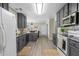Modern kitchen with gray cabinets, granite countertops, and stainless steel appliances at 3589 Garden Manor Dr, Loganville, GA 30052