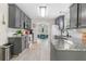 Well-lit kitchen features granite countertops, grey cabinets, stainless steel appliances, and hardwood floors at 3589 Garden Manor Dr, Loganville, GA 30052
