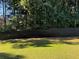 Grassy backyard enclosed by a dark wood privacy fence, shaded by mature trees at 704 Kenton Ct, Locust Grove, GA 30248
