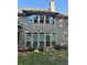 Back exterior of the house with brick and a lush green yard at 704 Kenton Ct, Locust Grove, GA 30248