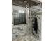 Contemporary bathroom featuring a glass-enclosed shower and stylish marble-look tile at 704 Kenton Ct, Locust Grove, GA 30248