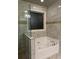 Bathroom featuring a soaking tub with glass partition, neutral tile, and modern fixtures at 704 Kenton Ct, Locust Grove, GA 30248
