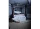 This is the main bedroom with a regal four-poster bed and sitting area bathed in soft light at 704 Kenton Ct, Locust Grove, GA 30248