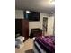 Cozy bedroom featuring a large TV, storage cabinet, and Murphy bed at 704 Kenton Ct, Locust Grove, GA 30248