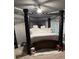 Bedroom with a four-poster bed and decorative features at 704 Kenton Ct, Locust Grove, GA 30248