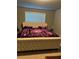 Cozy bedroom features a tufted headboard and a window with blinds at 704 Kenton Ct, Locust Grove, GA 30248