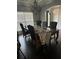 Classic dining room with a dark wood table, chandelier, and dark hardwood flooring at 704 Kenton Ct, Locust Grove, GA 30248
