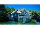 Beautiful two-story brick home with lush lawn, mature trees and inviting covered front porch at 704 Kenton Ct, Locust Grove, GA 30248