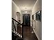 Grand foyer with dark wood floors, staircase and elegant lighting fixture at 704 Kenton Ct, Locust Grove, GA 30248