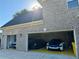 Spacious three-car garage featuring a variety of vehicles and ample storage at 704 Kenton Ct, Locust Grove, GA 30248