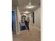 Hallway with stairs leading to a finished basement, decorated with a Theater sign at 704 Kenton Ct, Locust Grove, GA 30248