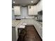 Bright kitchen with white cabinetry, granite counters, stainless appliances, and wood floors at 704 Kenton Ct, Locust Grove, GA 30248