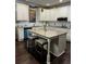 Gourmet kitchen featuring stainless steel appliances and an island with breakfast bar at 704 Kenton Ct, Locust Grove, GA 30248
