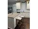 Bright kitchen with white cabinetry, granite counters, stainless appliances, and wood floors at 704 Kenton Ct, Locust Grove, GA 30248