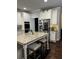 Spacious kitchen with granite counters, stainless appliances and an island with seating at 704 Kenton Ct, Locust Grove, GA 30248