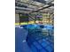 Sparkling in-ground pool featuring unique mosaic tile finish, lounging area and clear enclosure at 704 Kenton Ct, Locust Grove, GA 30248