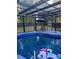 Enclosed in-ground pool with outdoor seating, backyard views, and sunny ambiance at 704 Kenton Ct, Locust Grove, GA 30248