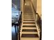 Staircase features decorative wrought iron, hardwood treads, and white risers at 704 Kenton Ct, Locust Grove, GA 30248