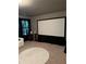 Home theater room with a large screen and comfortable seating at 704 Kenton Ct, Locust Grove, GA 30248