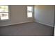 Neutral bedroom featuring two windows and wall-to-wall carpeting at 920 Crescent Ridge Dr, Buford, GA 30518