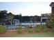 Lovely community pool with fenced perimeter, slides, and greenery, ideal for summertime fun at 920 Crescent Ridge Dr, Buford, GA 30518