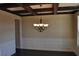 Elegant dining room with dark wood floors, coffered ceiling, wainscoting, and a chandelier at 920 Crescent Ridge Dr, Buford, GA 30518