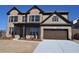 Charming two-story brick home features a manicured lawn and a two-car garage with an extended driveway at 920 Crescent Ridge Dr, Buford, GA 30518