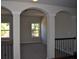 Open hallway with arched entries and iron railing at 920 Crescent Ridge Dr, Buford, GA 30518