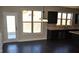 Spacious kitchen features stainless steel appliances, granite countertops, dark cabinets and an eat-in area at 920 Crescent Ridge Dr, Buford, GA 30518
