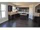 Well-appointed kitchen features dark cabinets, stainless steel appliances, and a central island for cooking and entertaining at 920 Crescent Ridge Dr, Buford, GA 30518