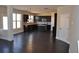 Open kitchen with stainless steel appliances, dark cabinetry, island, and hardwood floors at 920 Crescent Ridge Dr, Buford, GA 30518