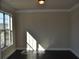 Sunlit living room with dark hardwood floors, neutral walls, and large windows at 920 Crescent Ridge Dr, Buford, GA 30518