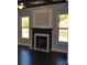 Living room featuring a fireplace with dark wood mantel and hardwood floors at 920 Crescent Ridge Dr, Buford, GA 30518