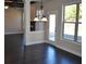Open-concept living space with hardwood floors, a large window, and seamless flow into the kitchen at 920 Crescent Ridge Dr, Buford, GA 30518