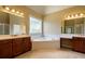 Open bathroom featuring dual vanities, a large tub, and lots of windows at 203 Crescent Moon Way Way, Canton, GA 30114