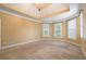 Bright and airy bedroom with large windows, a tray ceiling, and neutral carpet at 203 Crescent Moon Way Way, Canton, GA 30114