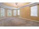 Spacious bedroom with multiple windows, a tray ceiling, and neutral carpet at 203 Crescent Moon Way Way, Canton, GA 30114