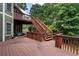 This outdoor wood deck features wood railings and stairs leading to the yard at 203 Crescent Moon Way Way, Canton, GA 30114