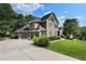 Beautiful home with a three-car garage and a well-manicured lawn and landscaped shrubbery at 203 Crescent Moon Way Way, Canton, GA 30114