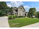 Beautiful home with a three-car garage and a well-manicured lawn and landscaped shrubbery at 203 Crescent Moon Way Way, Canton, GA 30114