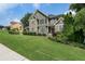 Charming two-story home with a stone and siding exterior and a beautifully manicured lawn at 203 Crescent Moon Way Way, Canton, GA 30114