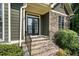 Charming home featuring stone steps leading to a glass-paneled front door at 203 Crescent Moon Way Way, Canton, GA 30114