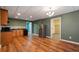This open kitchen has wood floors, oak cabinets, and stainless steel refrigerator at 203 Crescent Moon Way Way, Canton, GA 30114