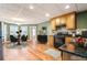 Open kitchen with stainless steel appliances, dining area, and hardwood floors at 203 Crescent Moon Way Way, Canton, GA 30114