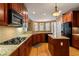 Spacious kitchen with granite counters, tile backsplash, modern appliances, and wood flooring at 203 Crescent Moon Way Way, Canton, GA 30114
