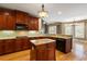 Cherry wood kitchen with granite countertops, stainless appliances, and a center island at 203 Crescent Moon Way Way, Canton, GA 30114