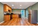 This kitchen features oak cabinetry, stainless steel refrigerator, and black appliances at 203 Crescent Moon Way Way, Canton, GA 30114