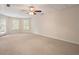 Spacious living area featuring neutral carpet, ceiling fan, and natural lighting at 203 Crescent Moon Way Way, Canton, GA 30114